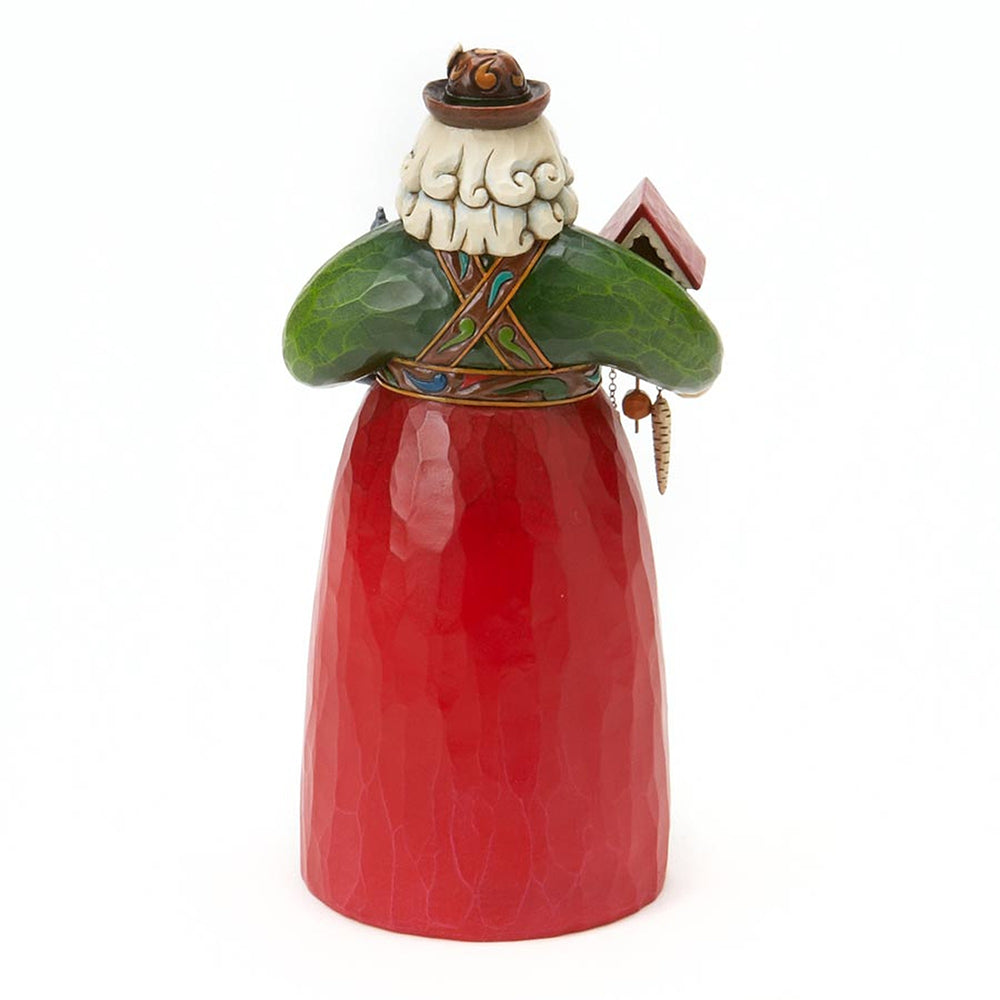 A ceramic Santa Claus figurine with a textured red skirt, green shoulders, a white beard, and a brown hat, shown against a plain white background.