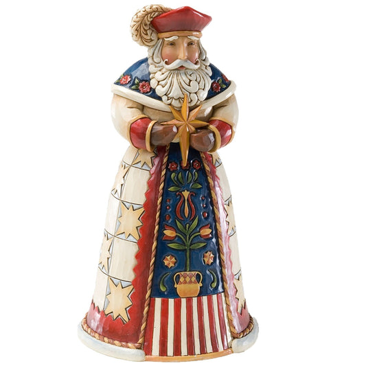 A decorative figurine of a Santa Claus-like figure with a red hat, white beard, and ornate red, blue, cream, and gold clothing, holding a gold star against a plain white background.
