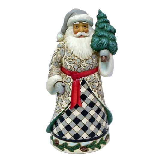 Decorative Santa Claus figurine holding a tree on a white background