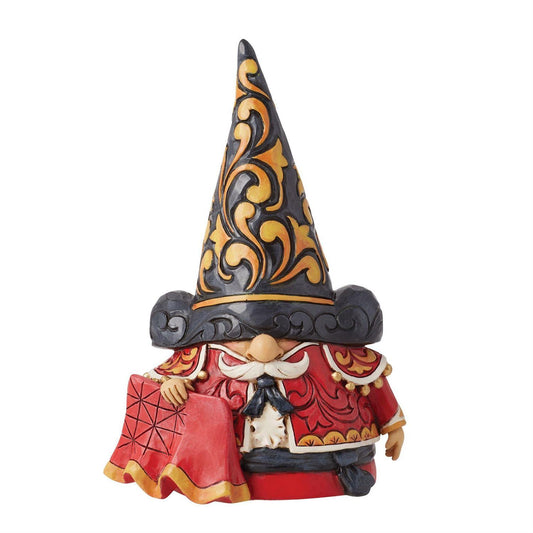 A Jim Shore collectible figurine of a gnome wearing a tall black hat with gold scrollwork, a red robe with gold trim, and a white mustache, shown on a plain white background.