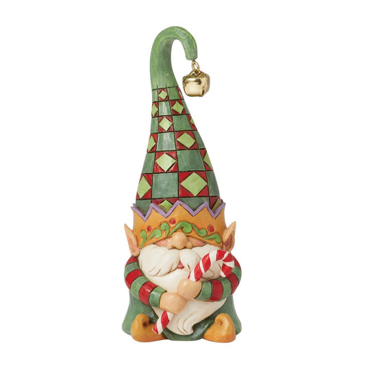 Decorative gnome figurine with a colorful hat and candy cane, on a white background
