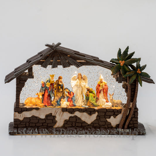 Decorative nativity scene with figures and a stable on a white background christmas snow globe