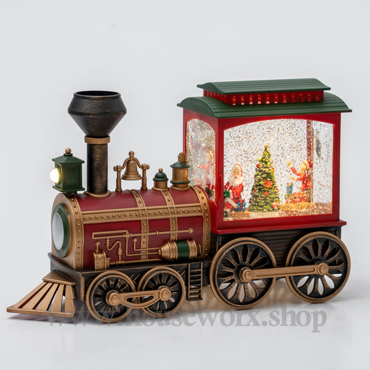 Decorative train-shaped water lamp with a Christmas scene inside on a white background