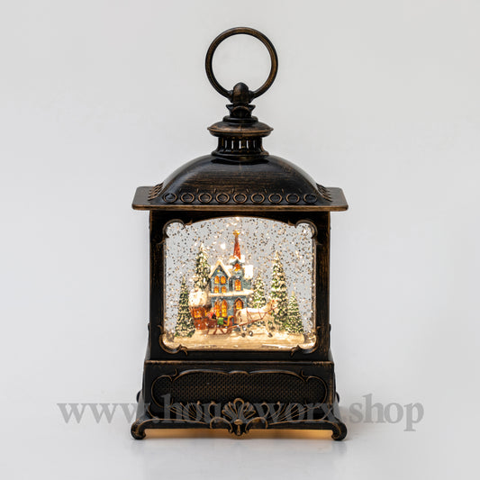 Decorative lantern with a miniature Christmas scene inside on a white background christmas snow globe