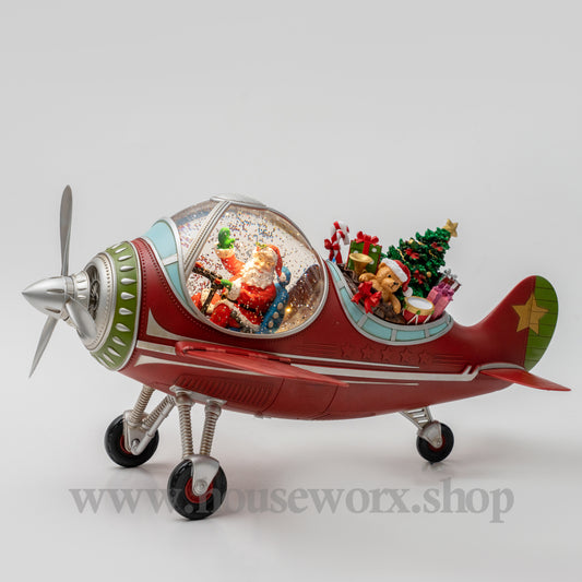 Decorative airplane with a snow globe inside on a white background