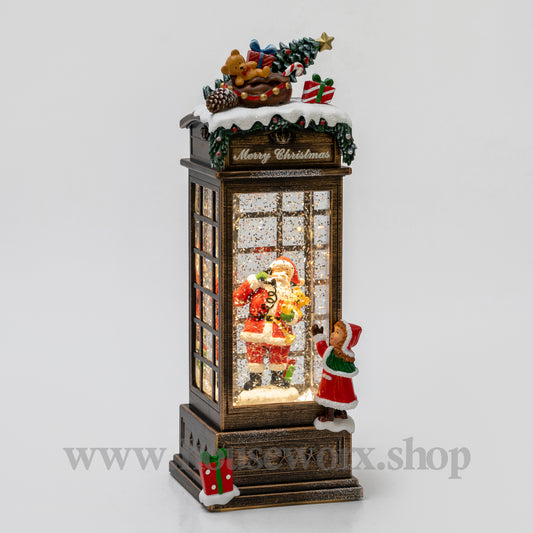 Decorative Christmas scene with Santa Claus and a child in a glass display case on a light gray Christmas snow globebackground.