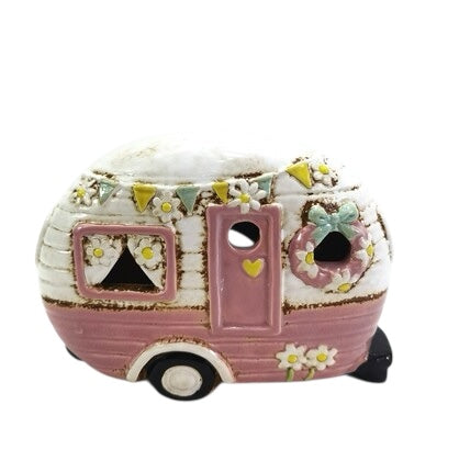 Decorative ceramic camper with floral patterns on a white background