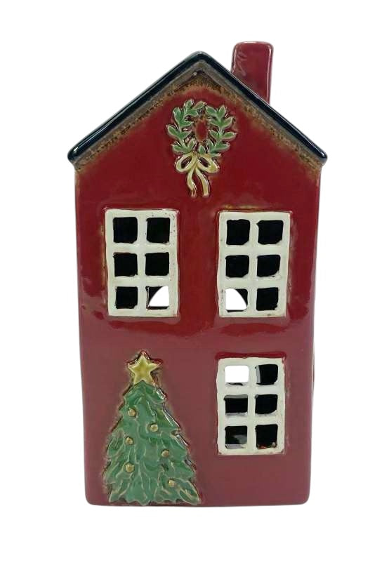 Decorative red house ornament with a wreath, windows, and a Christmas tree on a white background