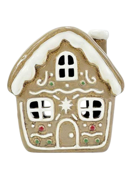 Decorative gingerbread house ornament on a white background