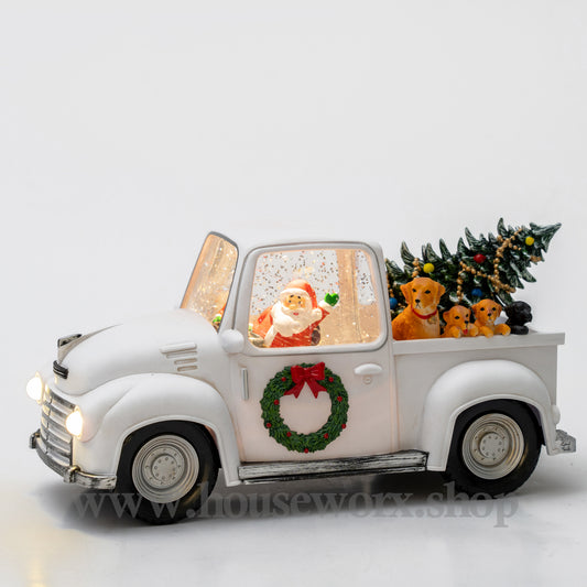 Decorative Christmas truck with Santa figure, wreath, and tree on a white background christmas snow globe
