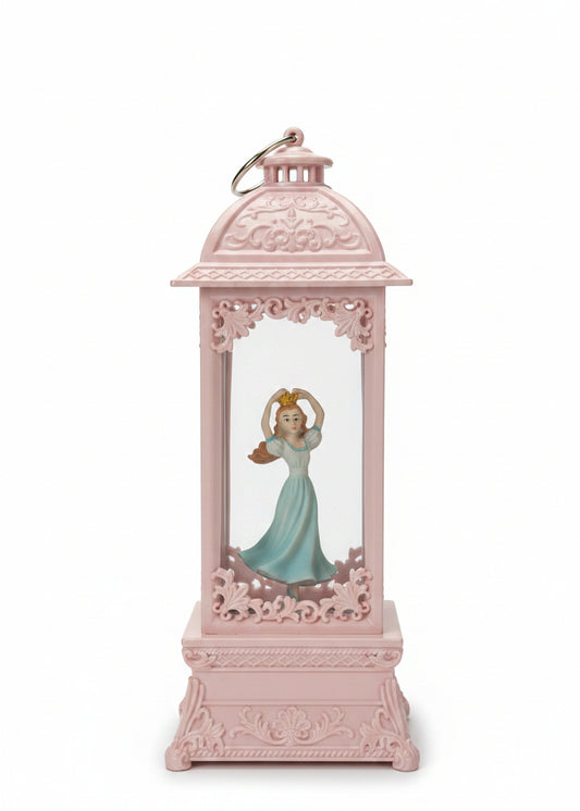 A pink decorative lantern-shaped ornament featuring a small figurine of Cinderella in a blue dress inside
