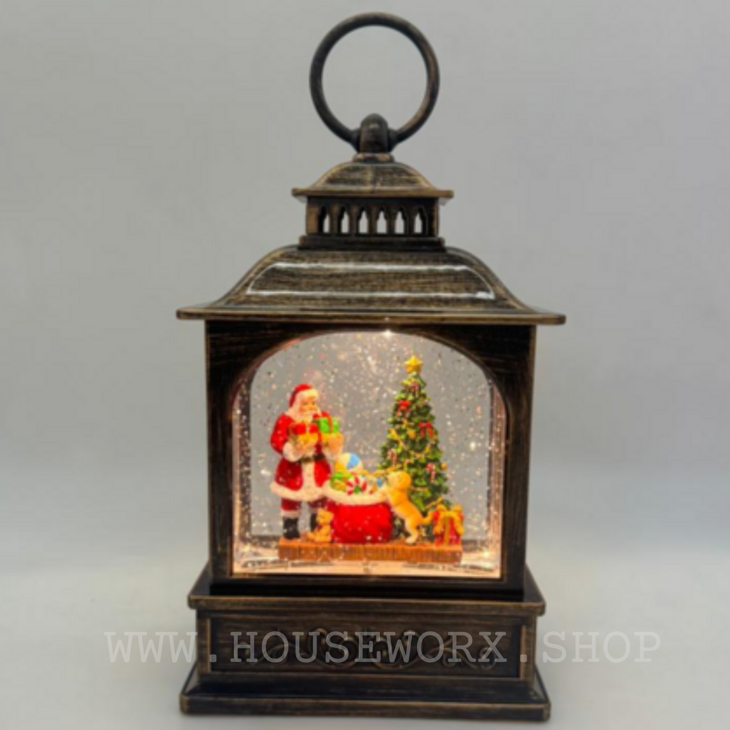 Decorative Christmas lantern with Santa Claus and tree inside, on a gray background.