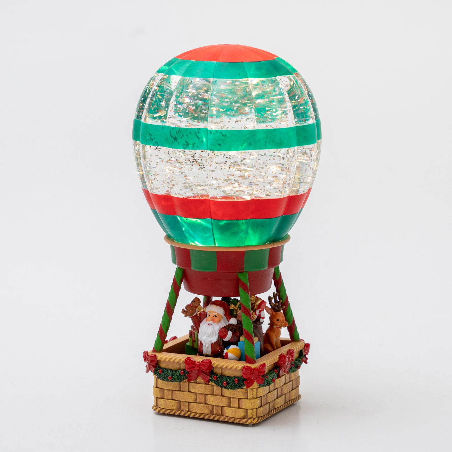 Decorative hot air balloon with Santa Claus and reindeer on a white background Christmas snow globe