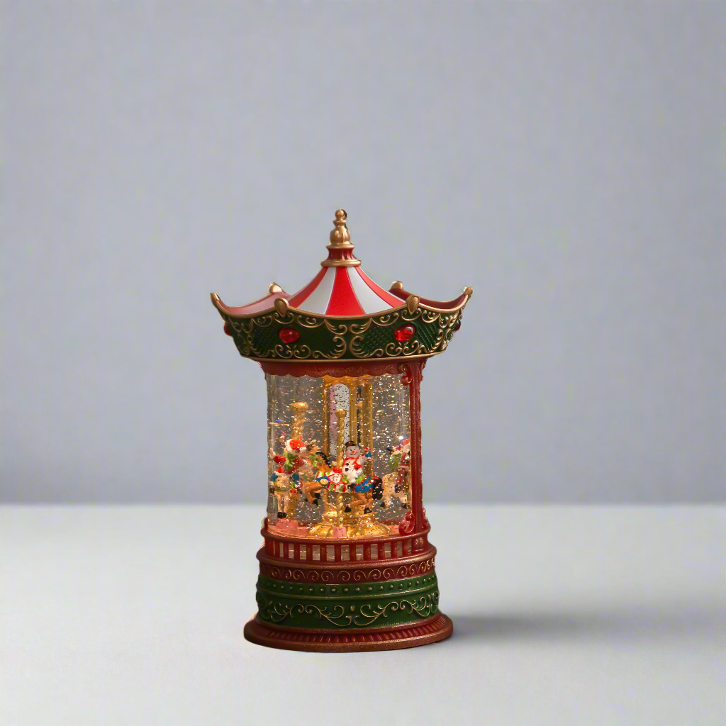 Decorative carousel-style water lamp with intricate details on a plain background