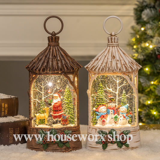 Two decorative lanterns with Christmas scenes inside, one brown and one white, against a festive background. Straw hut christmas snow globe