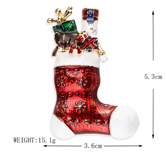 A red Christmas-themed brooch with a reindeer, snowflakes, and holiday decorations, measuring 5.3cm in height and 3.