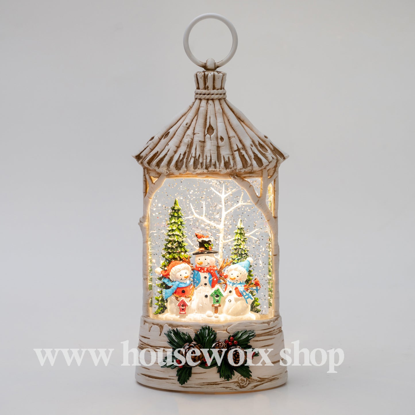 Decorative lantern with snowmen and Christmas trees inside, featuring the brand 'houseworx'. Straw hut christmas snow globe