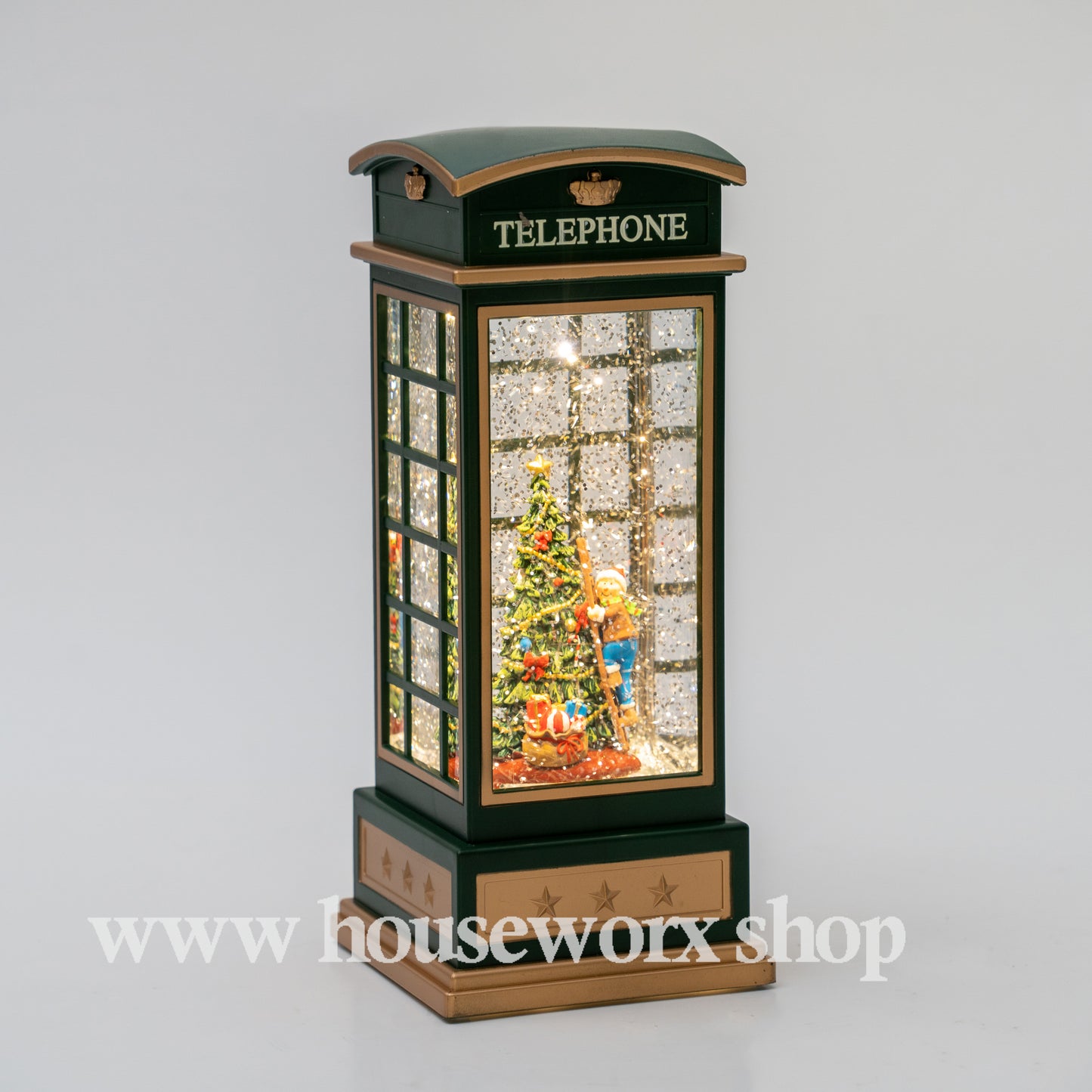 Decorative Christmas scene inside a miniature telephone booth with 'Houseworx' branding. christmas snow globe