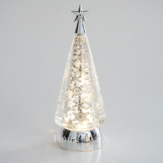 Decorative Christmas tree with a star on top against a gray background snow globe