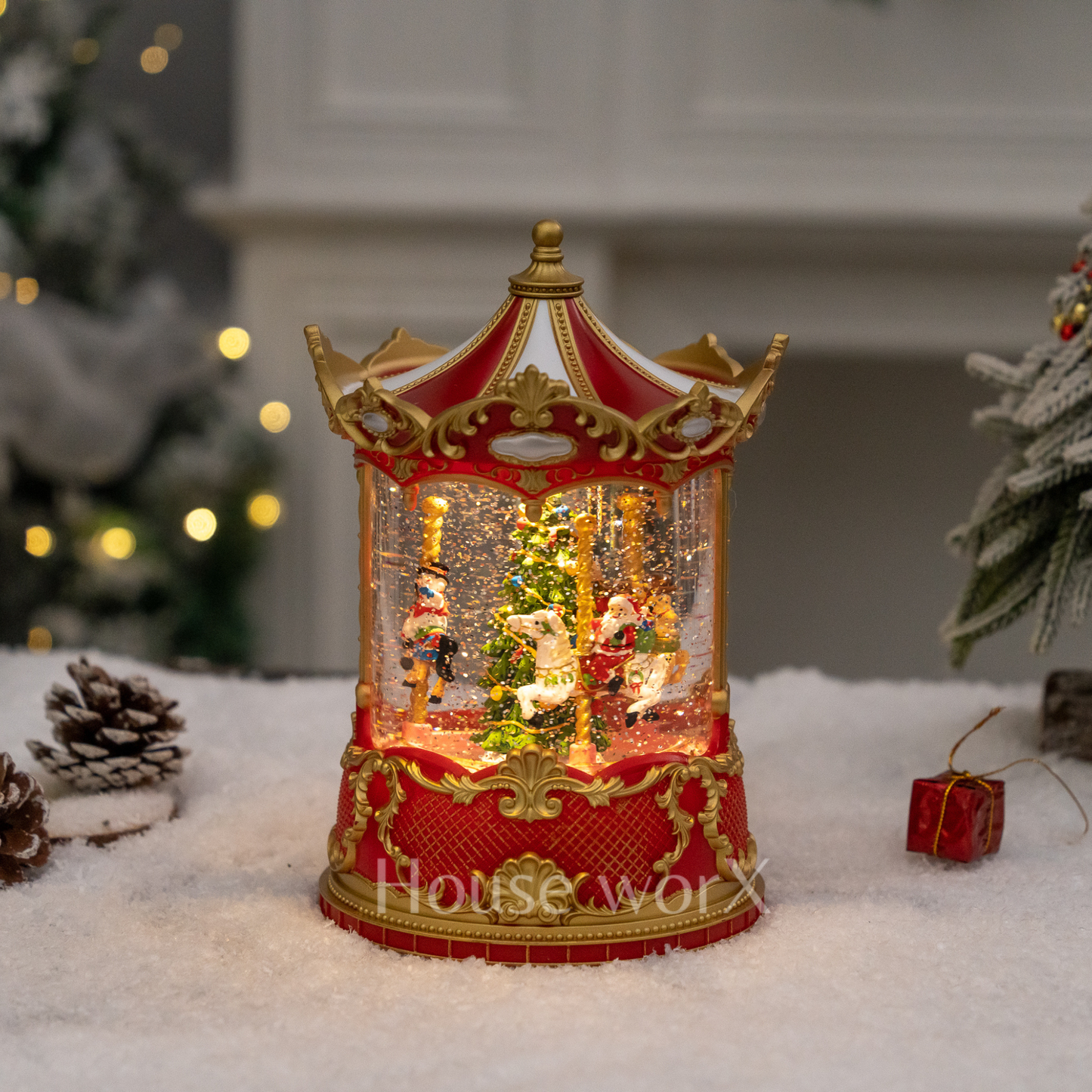 Decorative Christmas Snow Globe carousel with lights on a snowy surface, featuring 'House of Worx' branding.