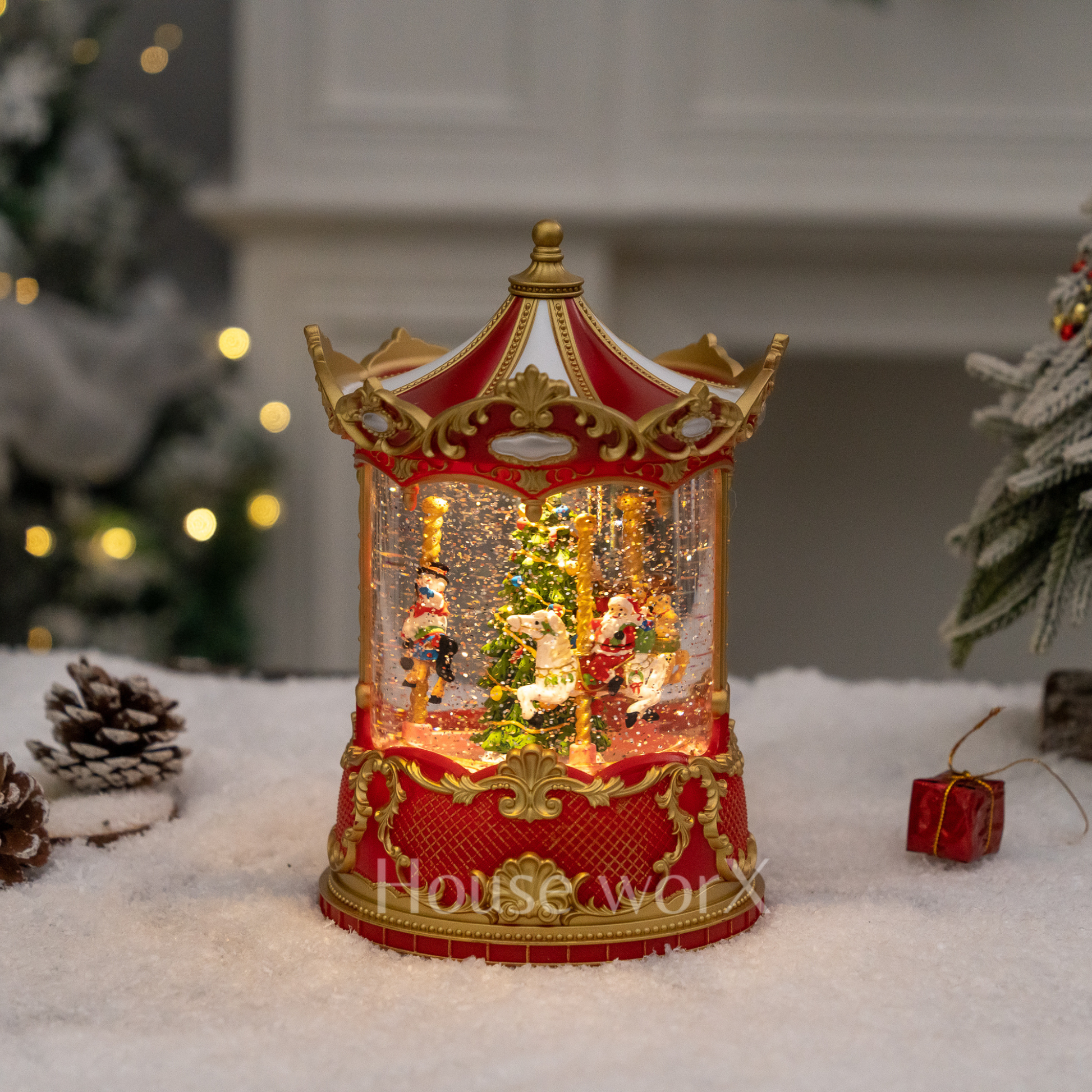 Decorative Christmas Snow Globe carousel with lights on a snowy surface, featuring 'House of Worx' branding.