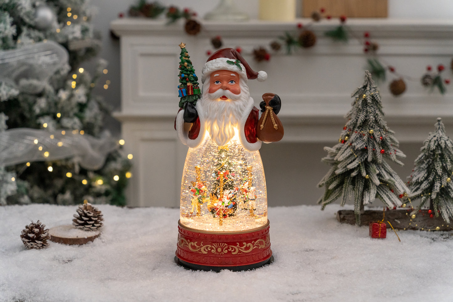 Decorative Christmas scene with a lit-up Santa Claus figure and trees in front of a fireplace.
