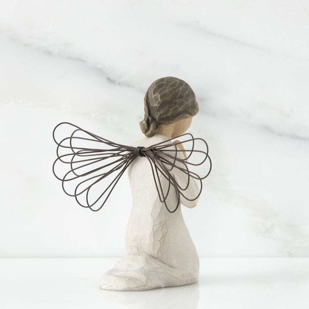 Decorative angel figurine with wire wings on a white background