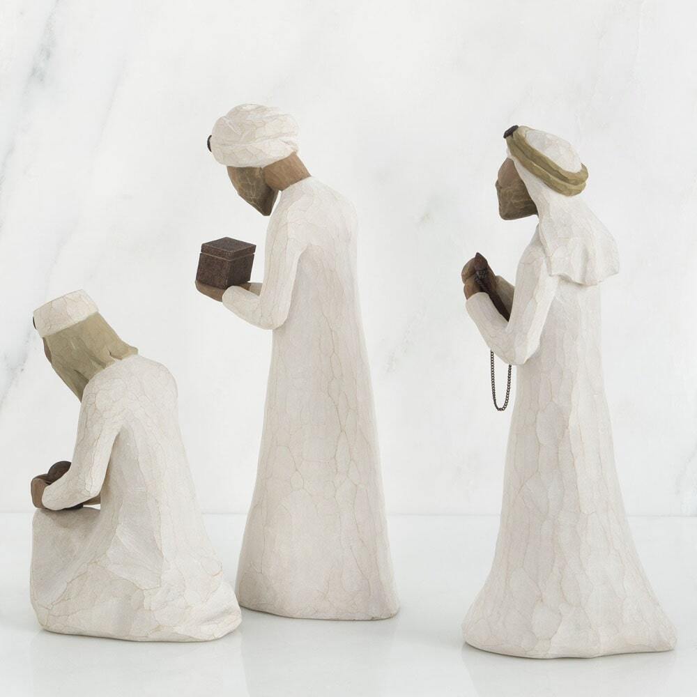 Three stone statues of people in traditional attire on a white background