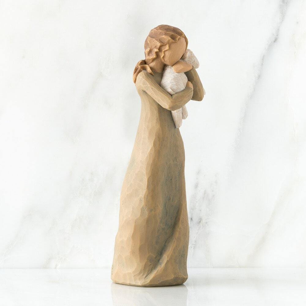Statue of a woman embracing a child on a white background