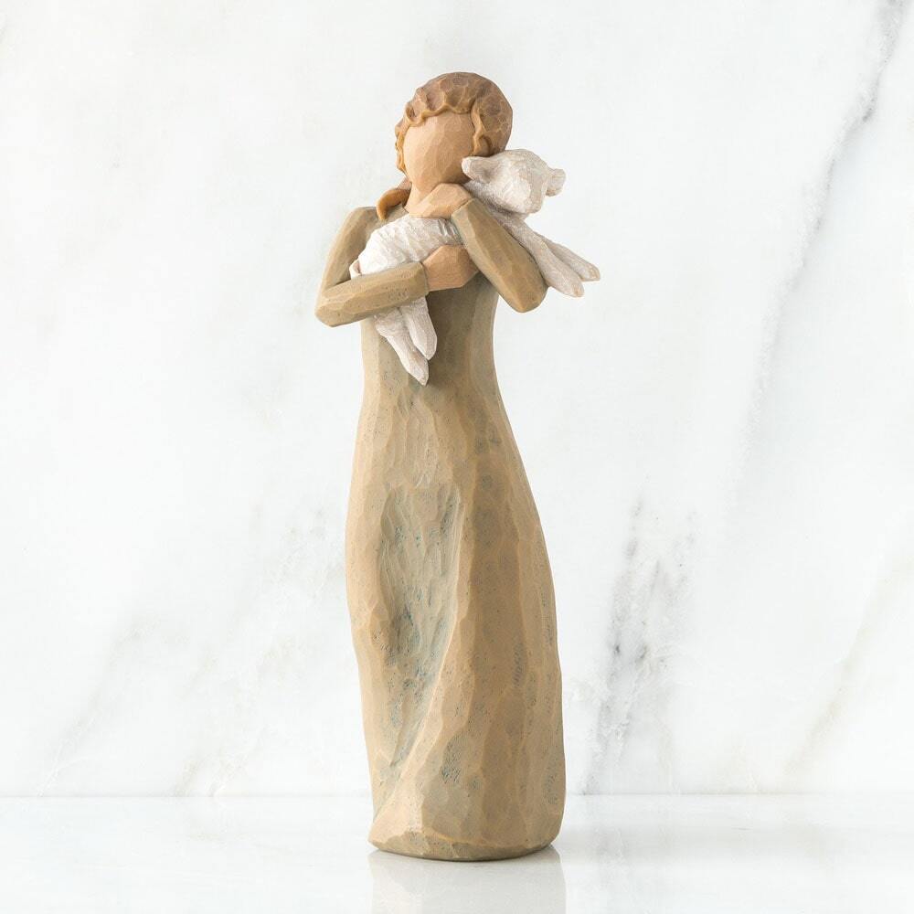 Statue of a woman holding a baby against a white background