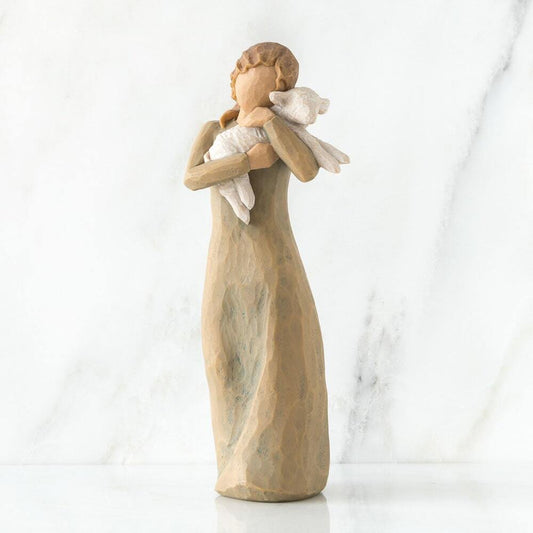 Statue of a woman holding a baby against a white background