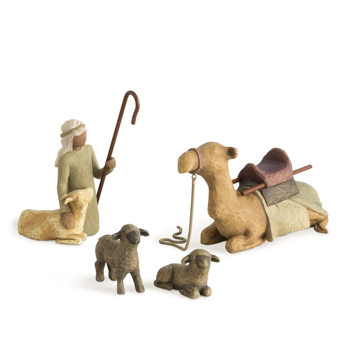 Set of nativity scene figurines including a shepherd, sheep, and camel on a white background
