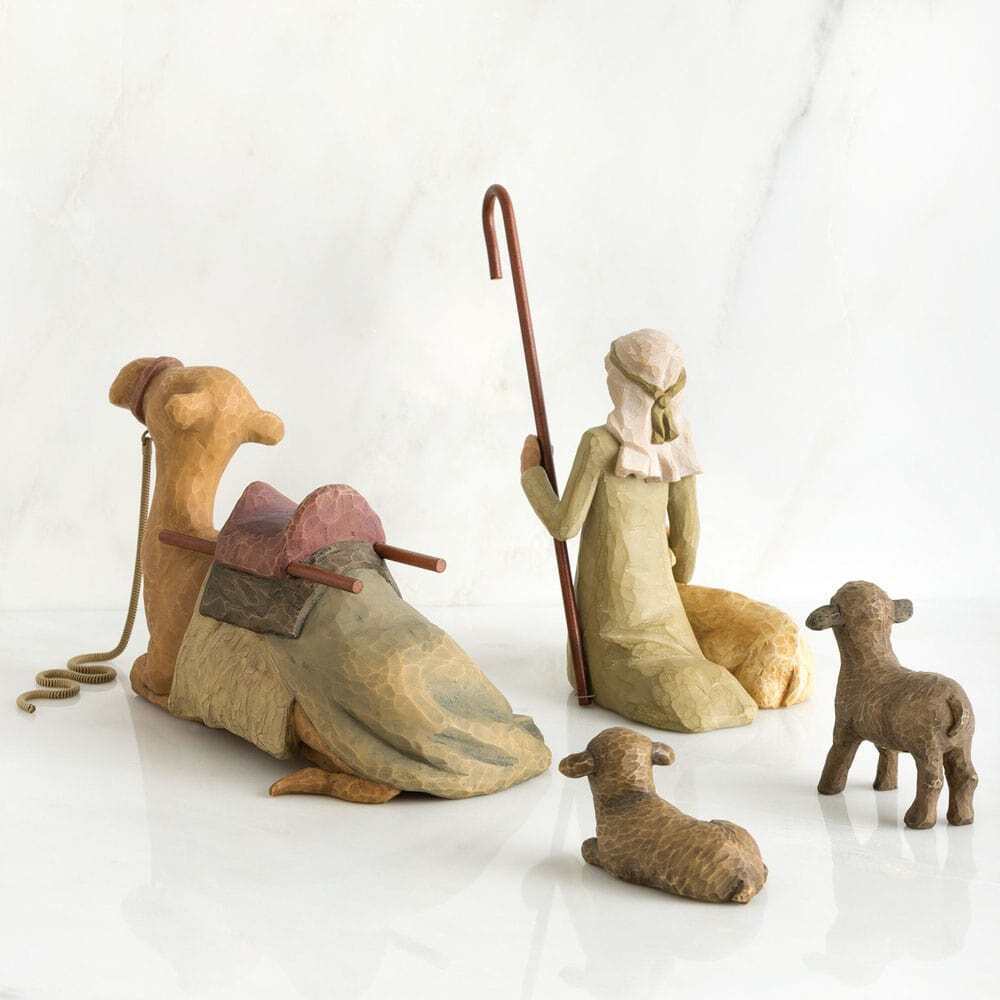 Wooden nativity scene figures on a white background