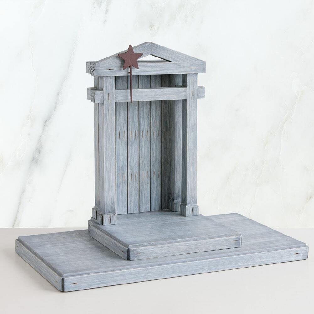 Gray wooden birdhouse with a star on a white background