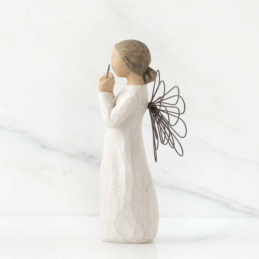 White figurine of a woman holding an open umbrella on a light gray background