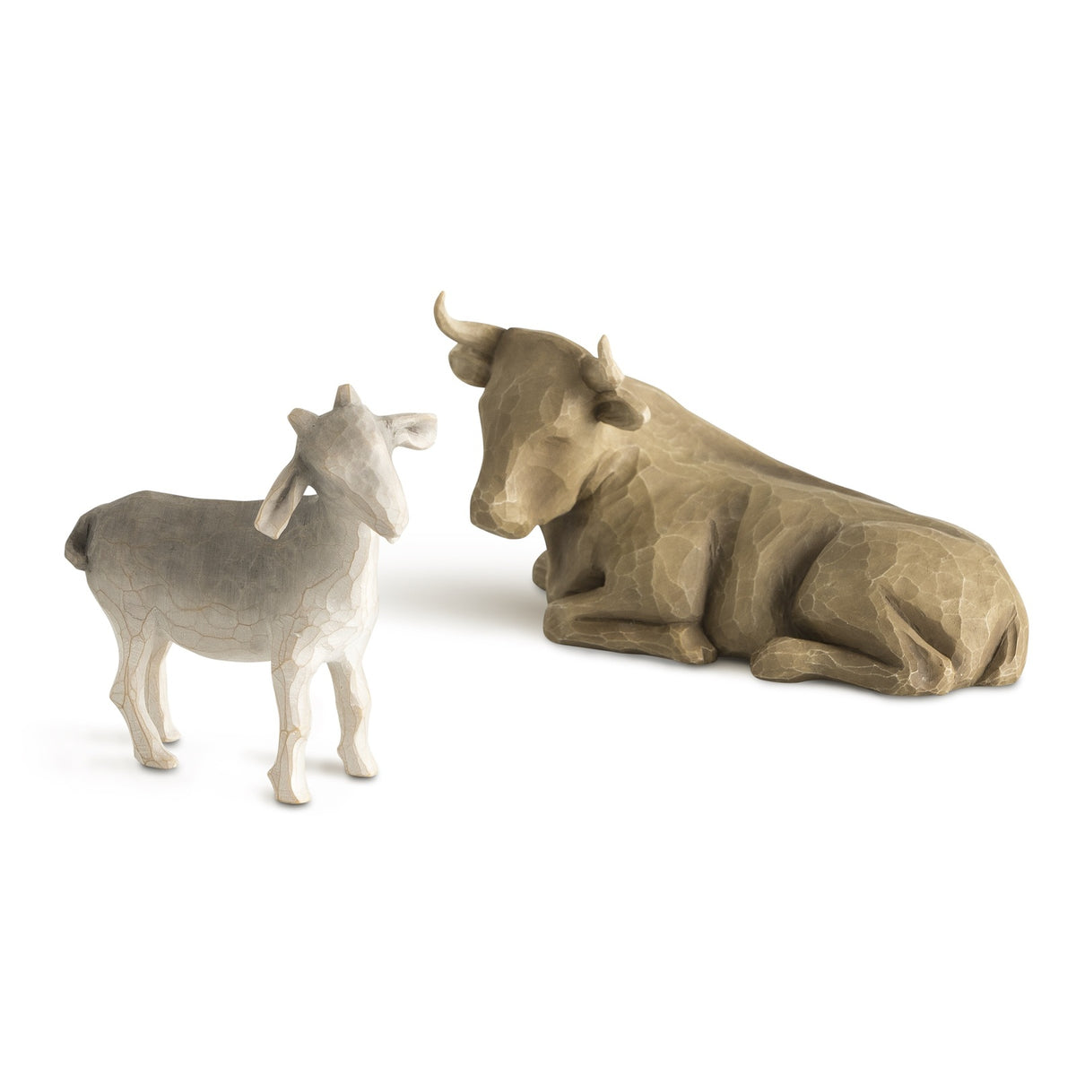 Small figurines of a bull and a goat on a white background