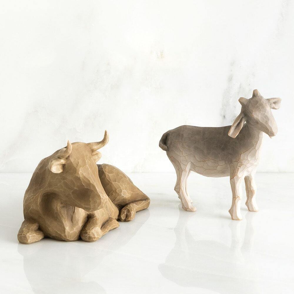 Two ceramic animal figurines, one resembling a deer and the other a cow, on a white background.