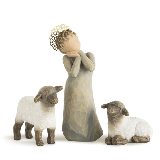 Decorative figurine of a woman with two sheep on a white background
