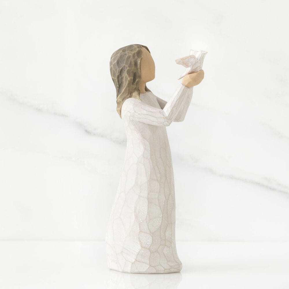 Statue of a woman holding a heart-shaped object on a white background