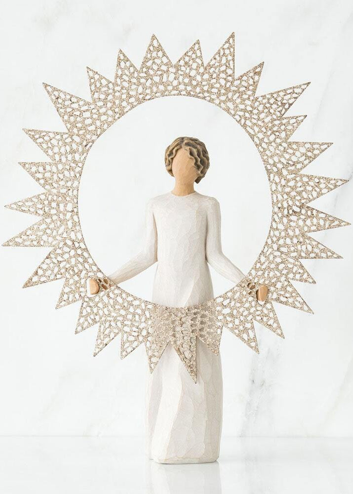 A Willow Tree figurine of a woman in a white dress holding a large, decorative sunburst frame, set against a white marble background.
