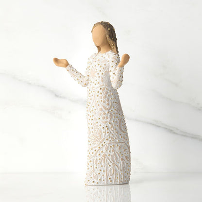 Statue of a woman in a white dress with lace details on a light gray background