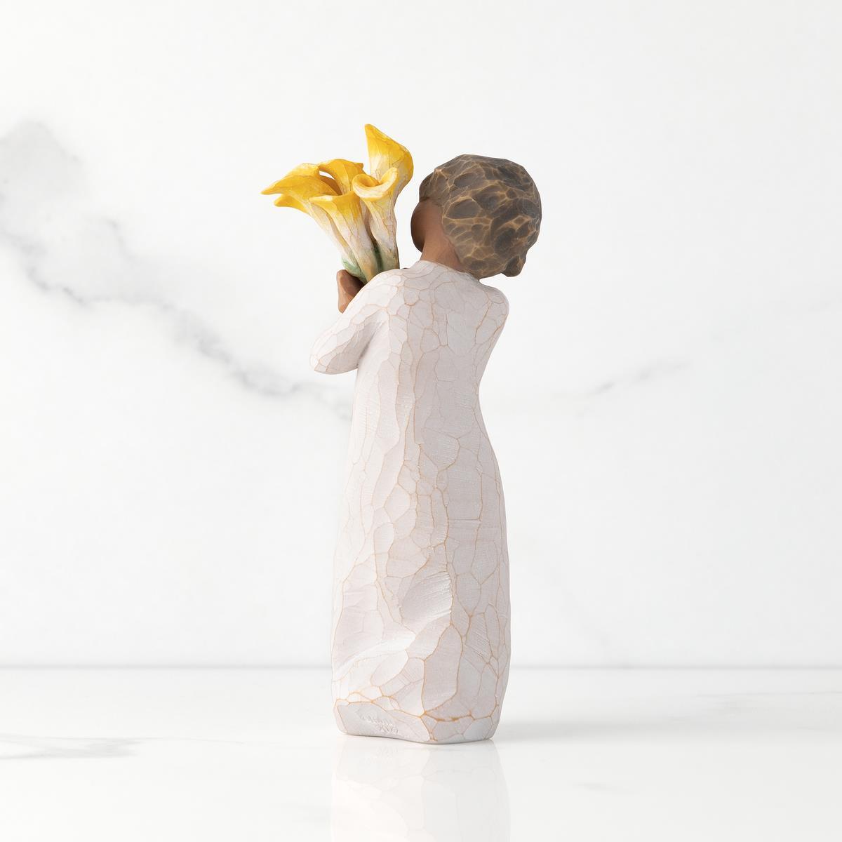 Statue of a woman holding flowers on a white background