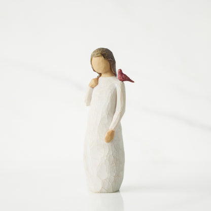 White figurine of a girl with a bird on her shoulder against a white background