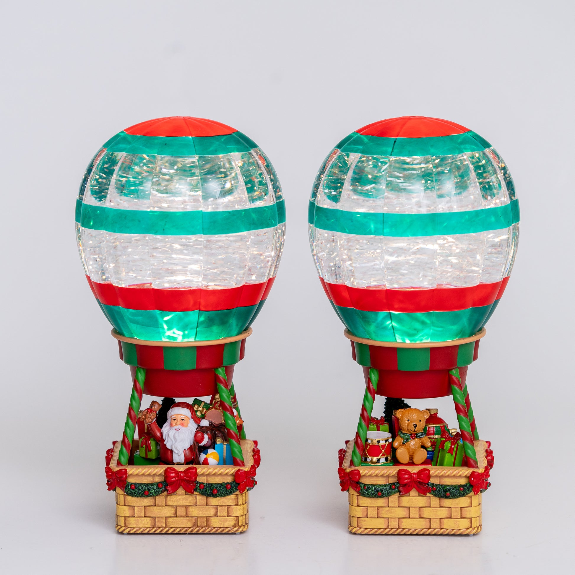 Two decorative hot air balloons with Christmas-themed decorations on a white background Christmas snow globe