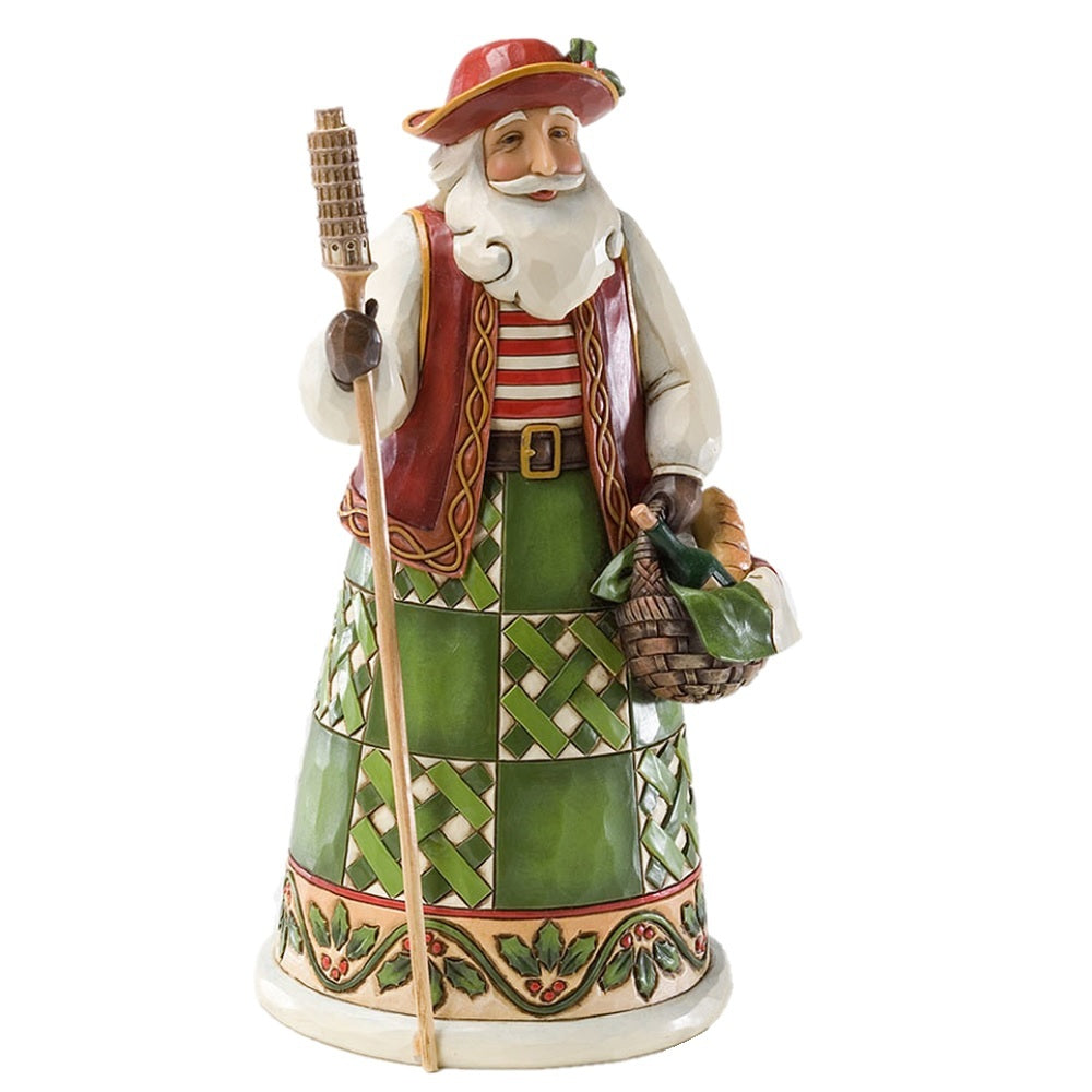 A ceramic Christmas figurine of a jovial old man dressed in festive holiday attire, featuring a red hat, red vest, striped shirt, green patterned skirt, and holding a staff and basket, set against a plain white background.
