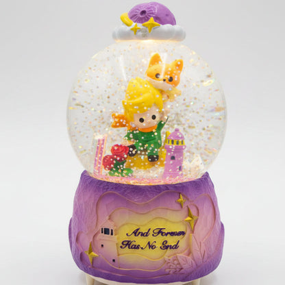 A purple and gold fairy-themed snow globe music box with a glowing interior, featuring a character in a green dress, a fox, and the phrase 'And Forever Has No End' on the base, shown on a kitchen countertop.