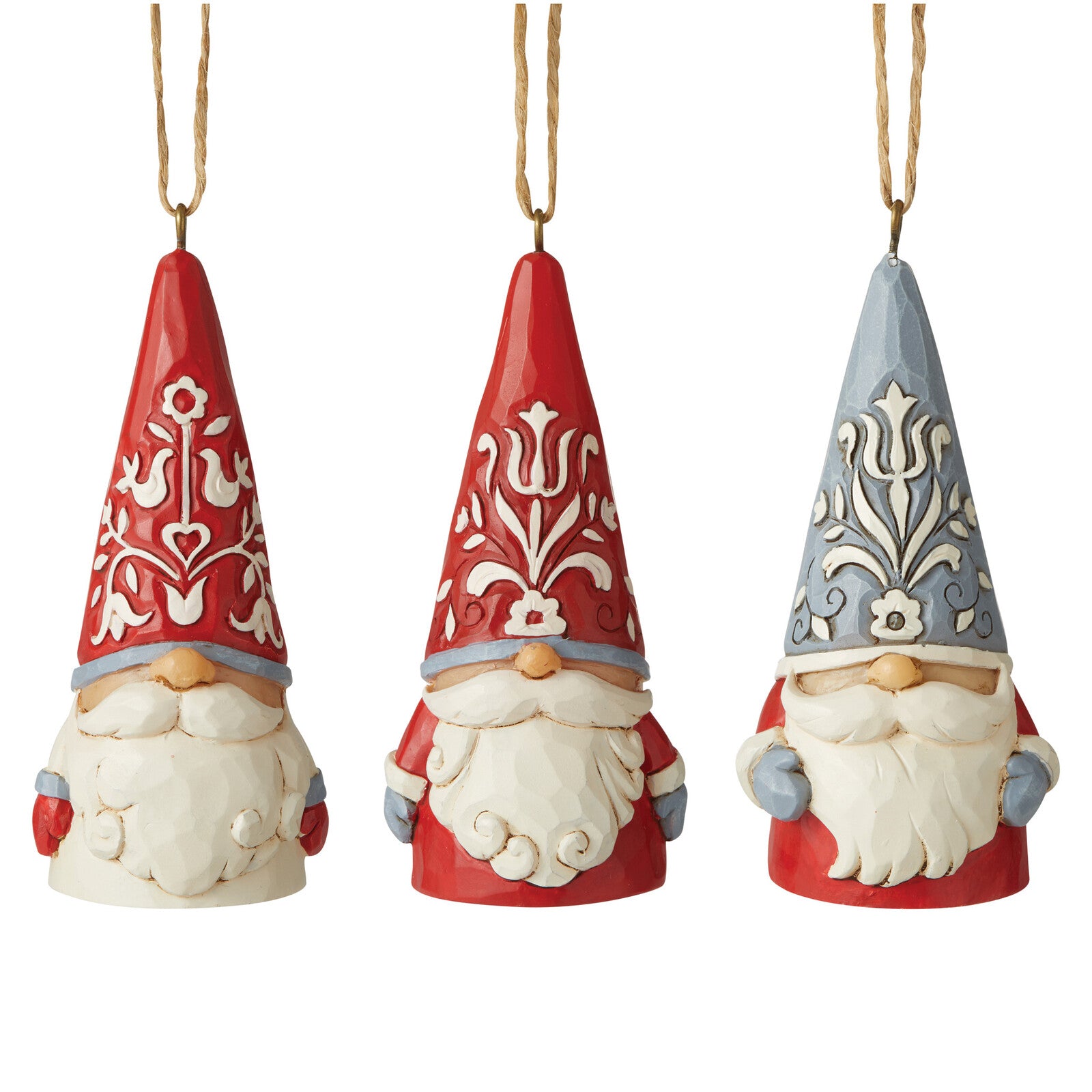 Three hanging gnome ornaments on a white background, each with a tall pointed hat and white beard. The left and center gnomes have red hats with white ornamental patterns and gray-blue bands; the right gnome has a red hat with a gray-blue ornamental pattern and gray-blue band.