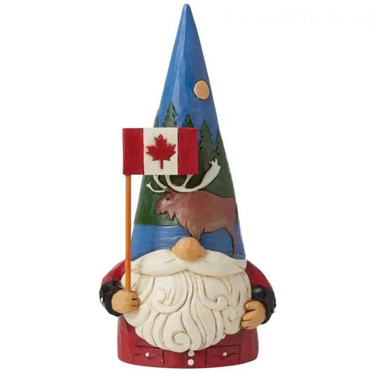 A decorative gnome figurine wearing a red jacket and white beard, holding a small Canadian flag. The tall blue hat features a painted moose, pine trees, moon, and stars.