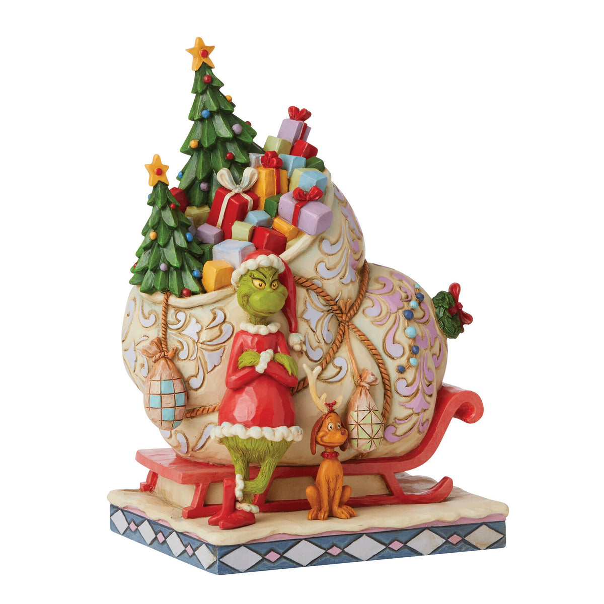 A decorative holiday figurine featuring the Grinch in a red Santa outfit standing beside a small orange cat, with a sleigh carrying a Christmas tree, ornaments, and wrapped gifts, shown on a plain white background.
