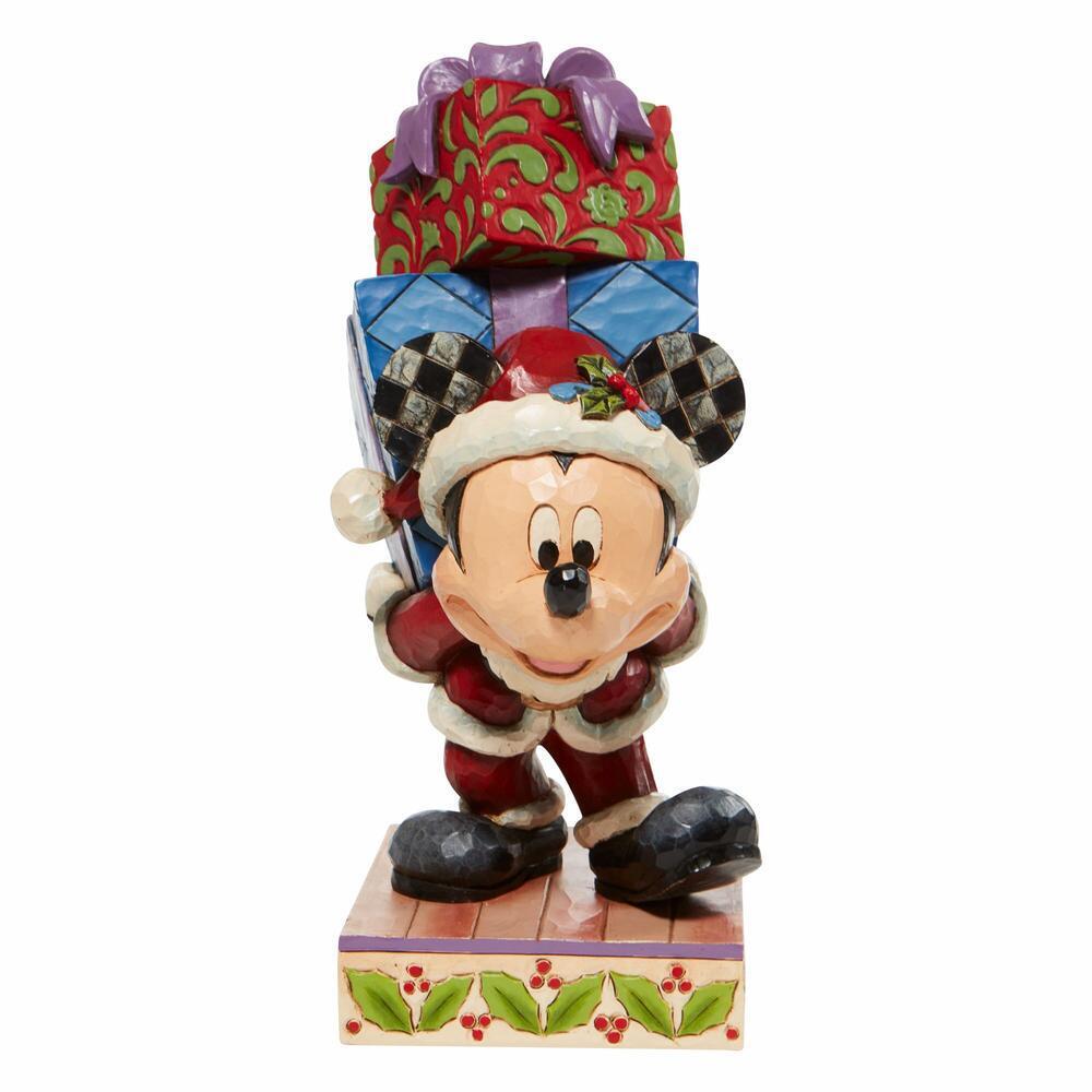 Mickey Mouse figurine wearing a Christmas hat with presents on a white background